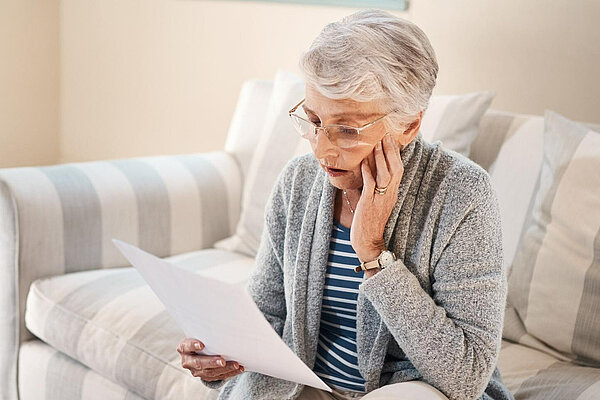 A lady looking at her bills.