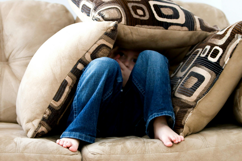 Child hidden under cushions