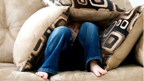 Child hidden under cushions